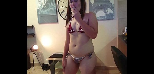  Girl having a smoke in a tiny bikini and getting nude